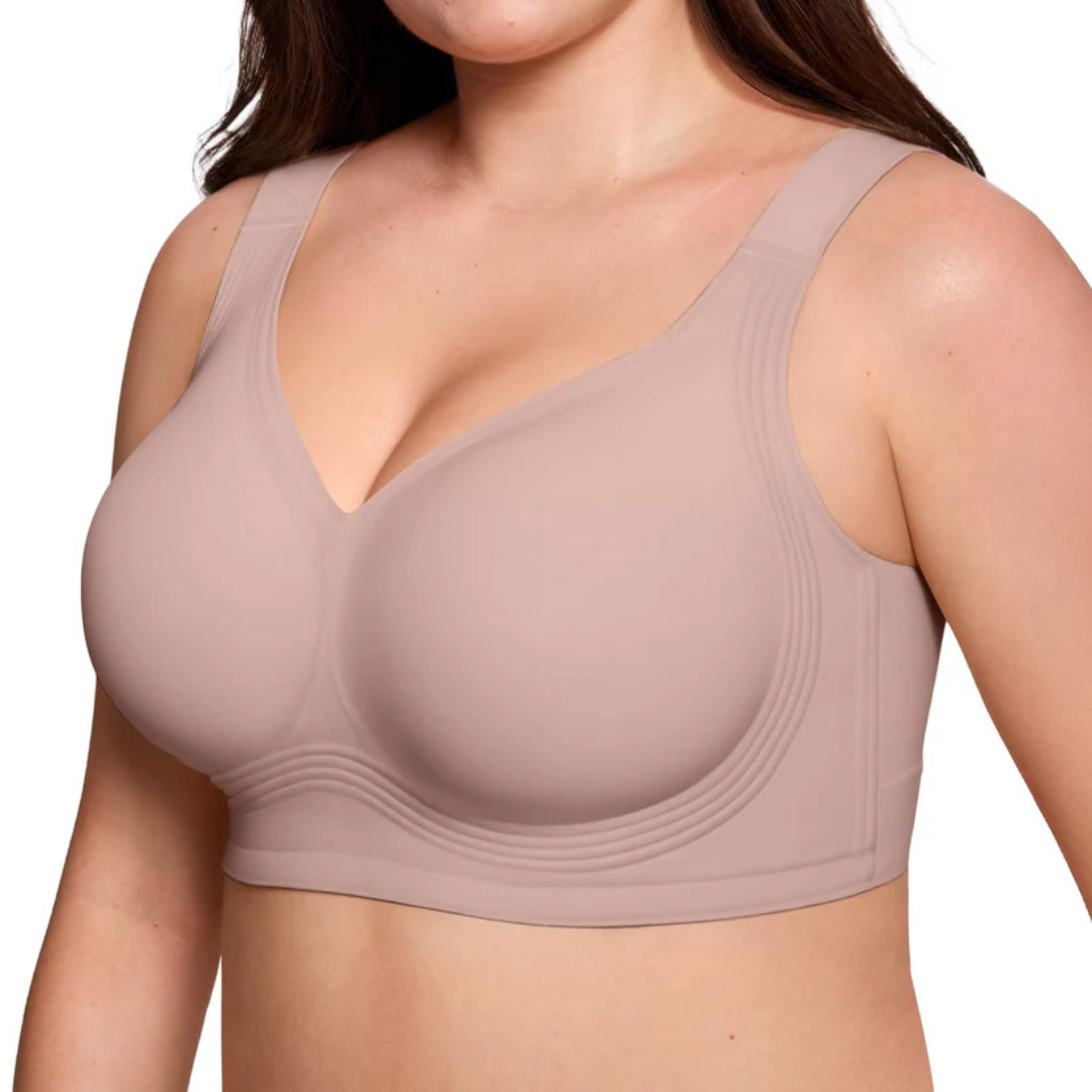 Three-quarter view of the dusky pink bra on a model, showing the smooth cups and ribbed band 8