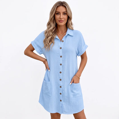 Pale blue crinkled shirt dress on a model with a hand in the pocket, studio backdrop 11