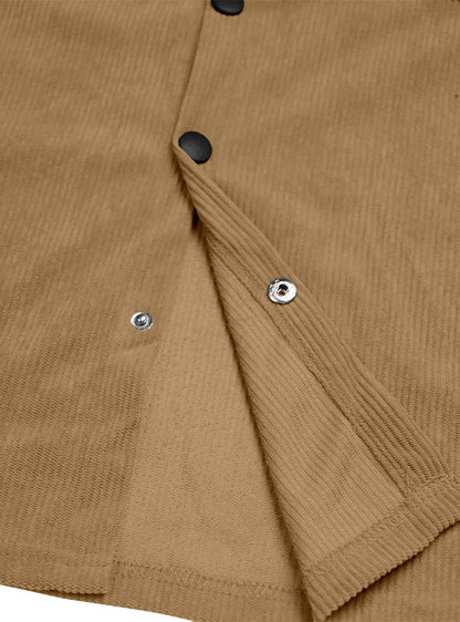 Close-up of the tan shirt's placket turned back, showing black buttons and metal snap fasteners 11