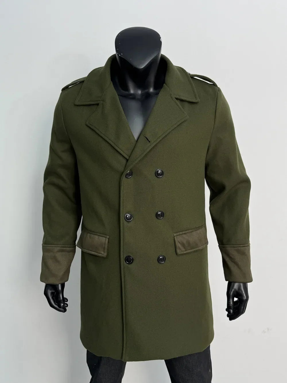Olive green overcoat on a mannequin, front view with black buttons, flap pockets and contrast suede-look cuffs 11
