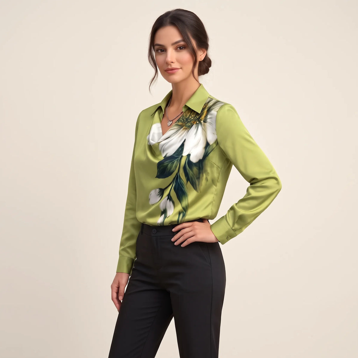 Model turned slightly sideways in a green satin blouse with large white flower print and black trousers 11