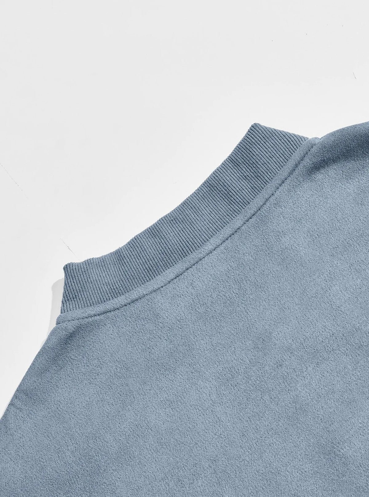 Back of the light blue jacket showing the ribbed collar and smooth shoulder panel 11