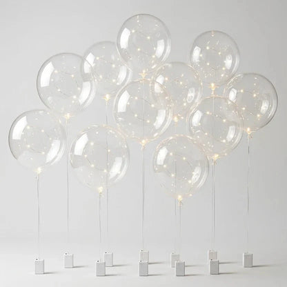 Ten clear balloons with warm LED string lights, each on a string with white battery box 8