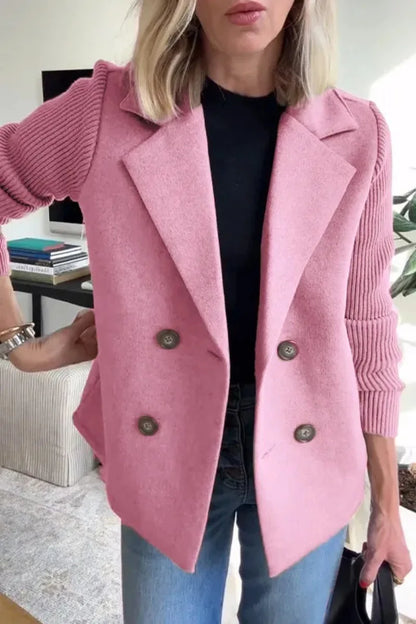Close-up of pink double-breasted jacket on model, showing notch lapels and ribbed knit sleeves 12