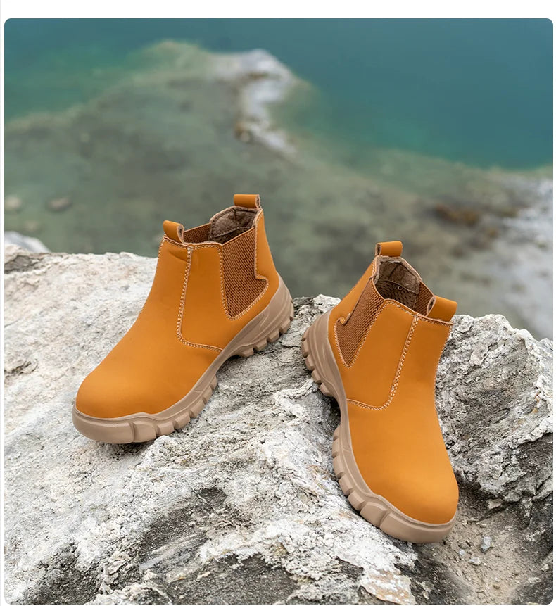 Pair of tan slip-on boots resting on pale rock, with a green-blue lake behind 12