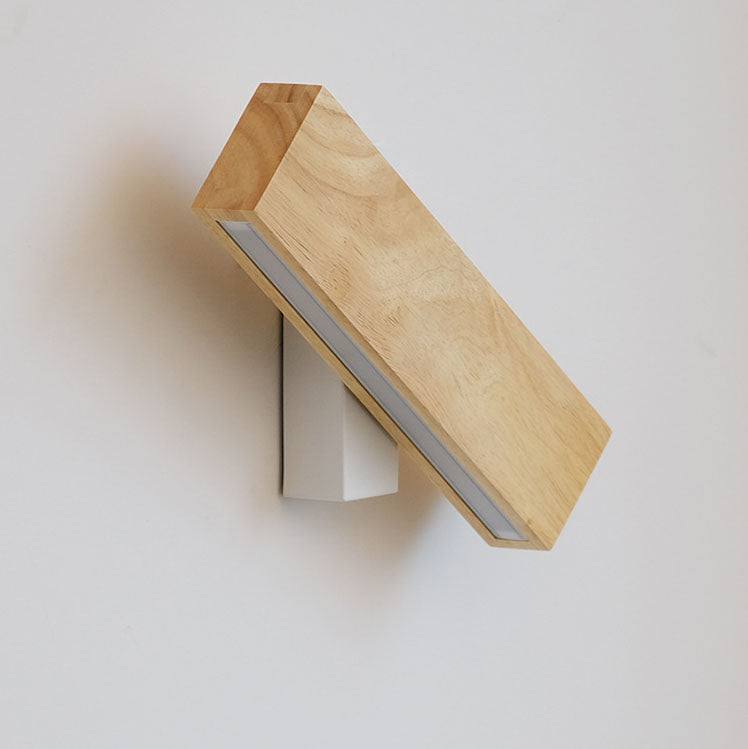 Switched-off wooden bar tilted on its white bracket, showing the frosted diffuser strip along its lower edge. 13