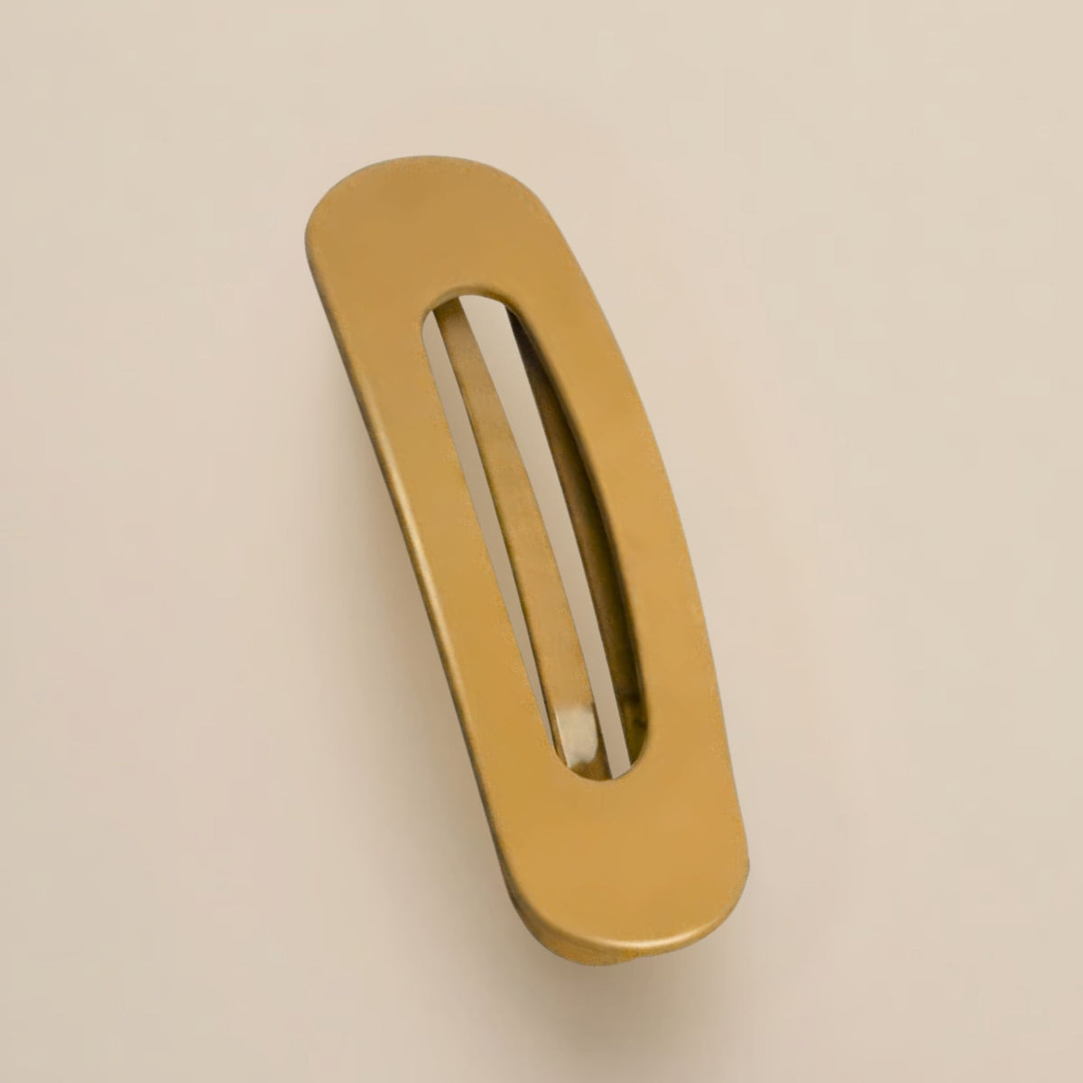 Matte mustard-yellow slim flat clip with a long open slot on a beige background 12