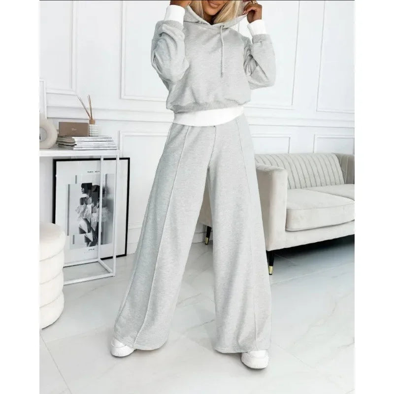 Light grey hooded set with white cuffs and hem, worn with white trainers 12