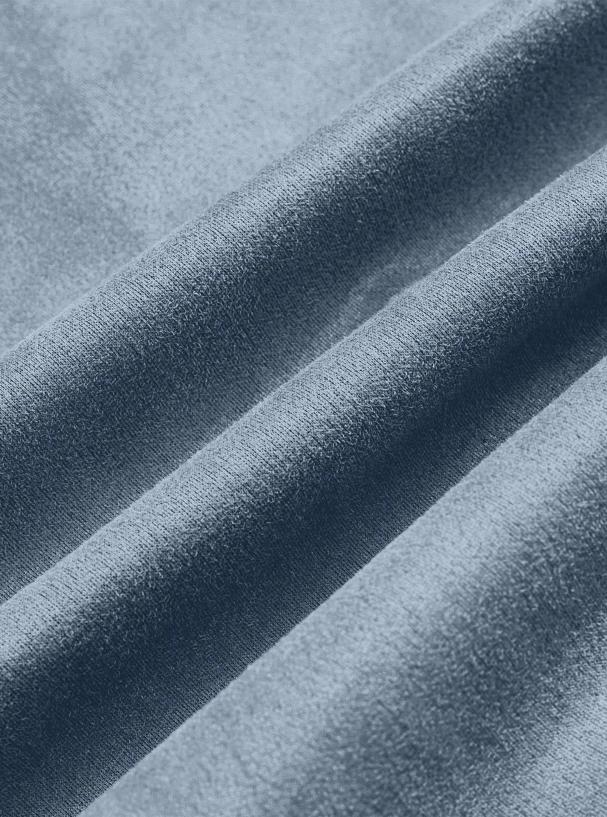Close-up of soft light blue suede-look fabric folded into gentle ridges 12