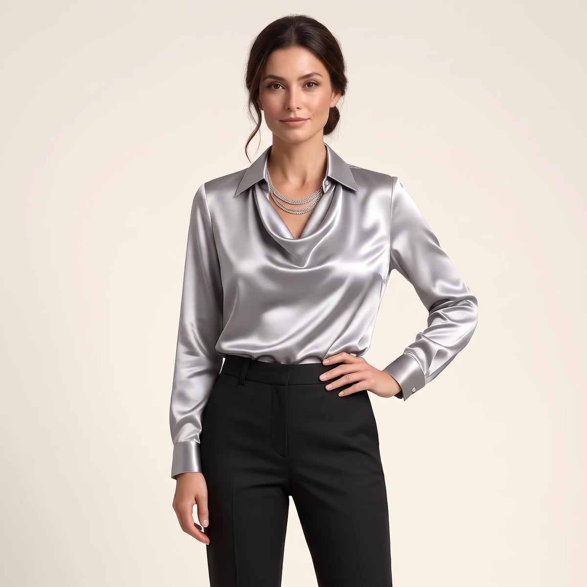 Model in a silver-grey satin blouse with layered crystal necklace, black trousers and hand on hip 13