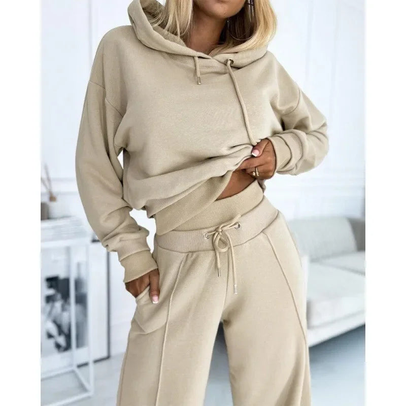 Close-up of the beige hoodie and ribbed-waist trousers, model's hand tucked into the pocket 13