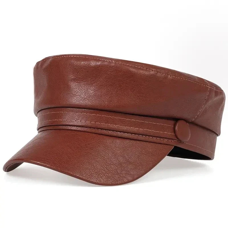 Brown faux leather baker boy hat, three-quarter view, with visible stitching along the band and peak 13