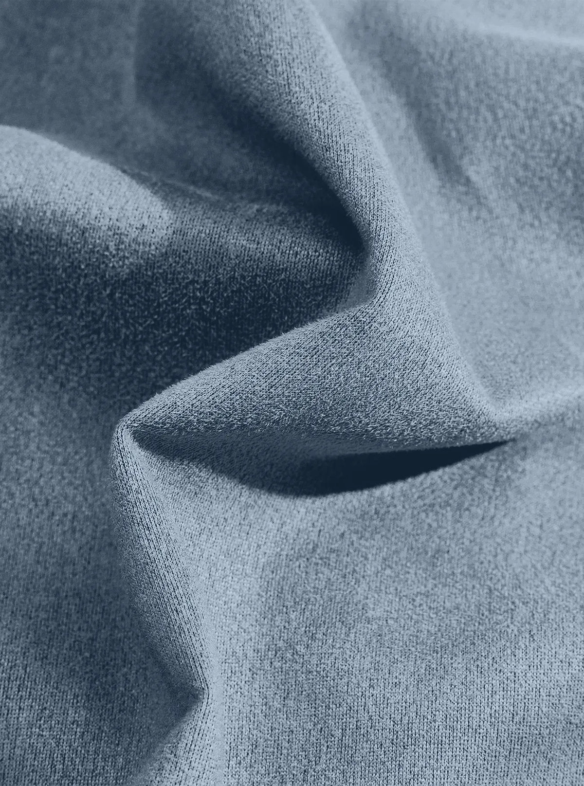 Extreme close-up of the light blue fabric texture draped in a soft fold 13