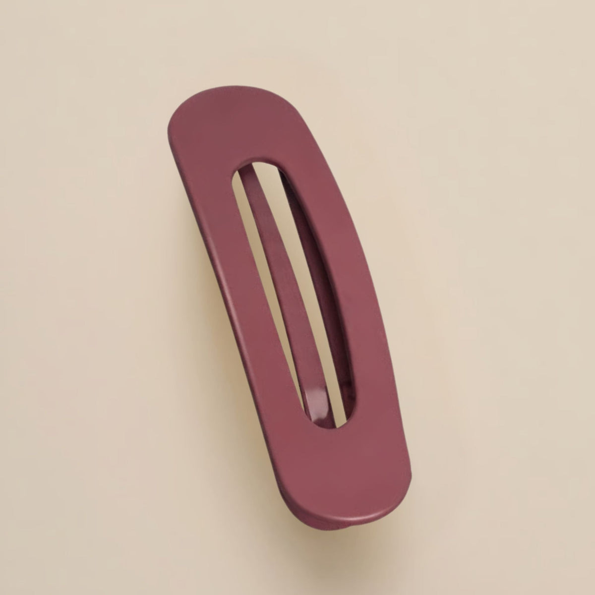 Matte burgundy slim flat clip with a long open slot on a beige background 13
