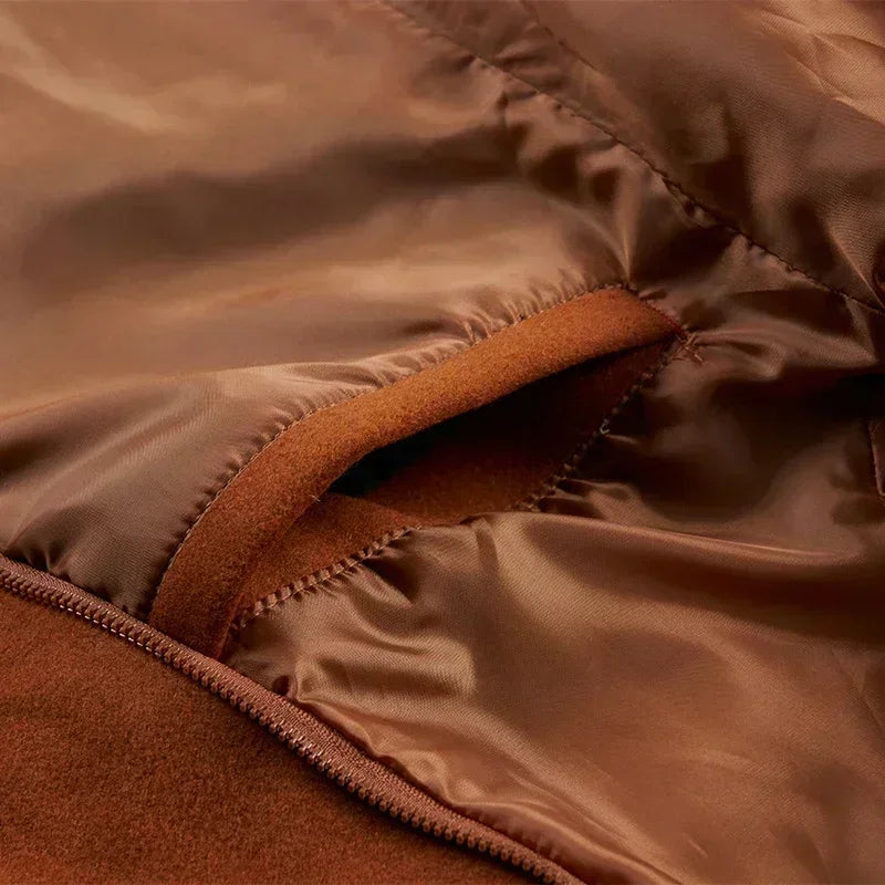 Close-up of the tan coat's inner pocket opening, surrounded by smooth satin-like lining fabric 13