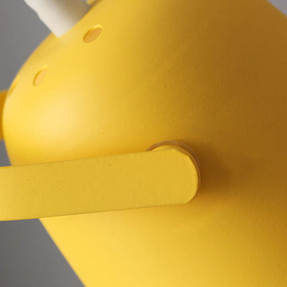 Detail of the yellow shade's side with ventilation holes and the short pivot arm joining it to the stem. 3
