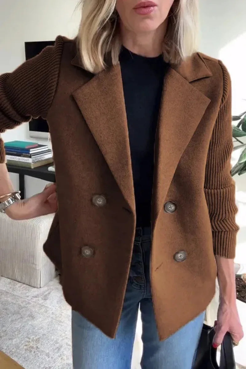 Close-up of brown double-breasted jacket on model, showing turn-down collar, buttons and ribbed sleeves 14
