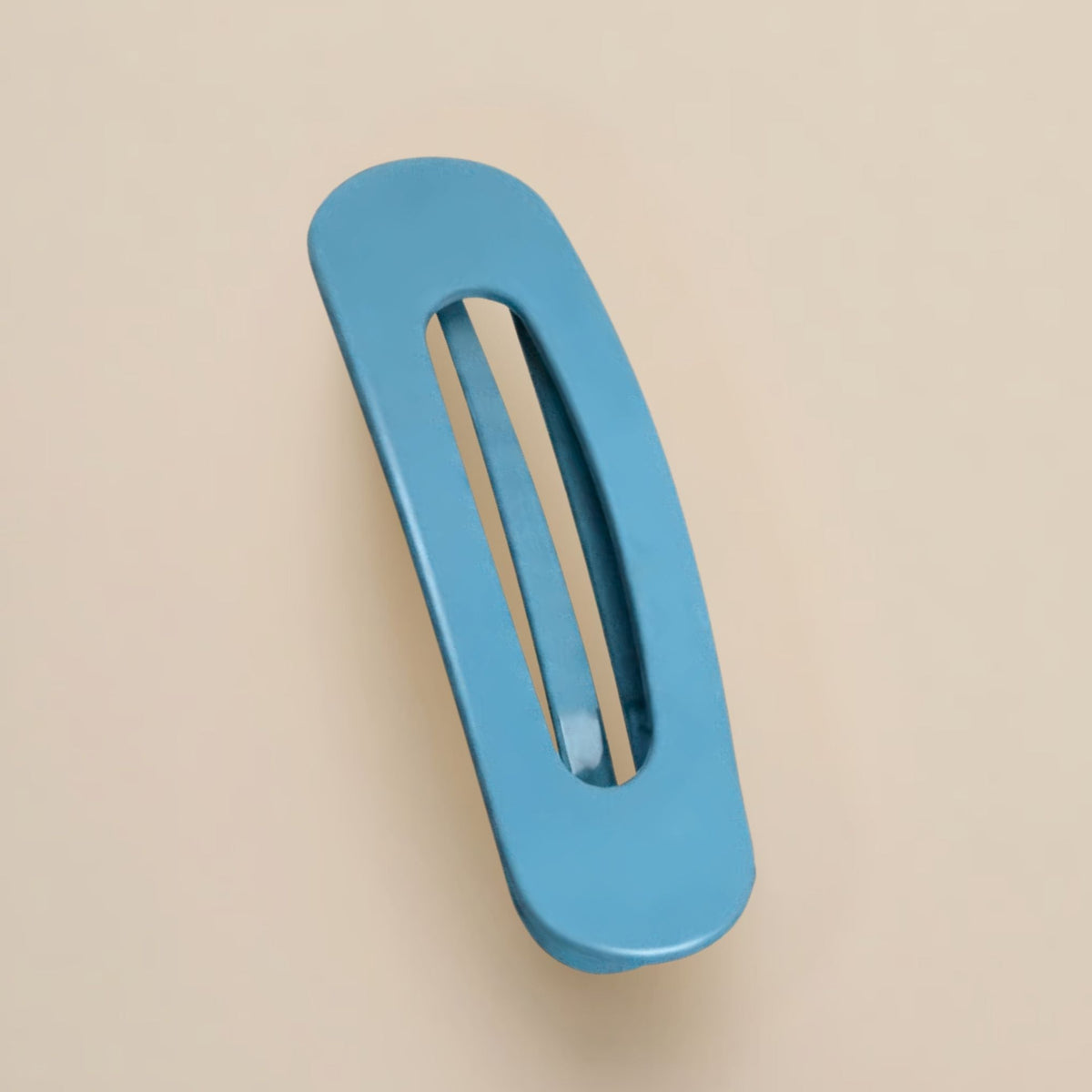 Matte sky-blue slim flat clip with a long open slot on a beige background 14