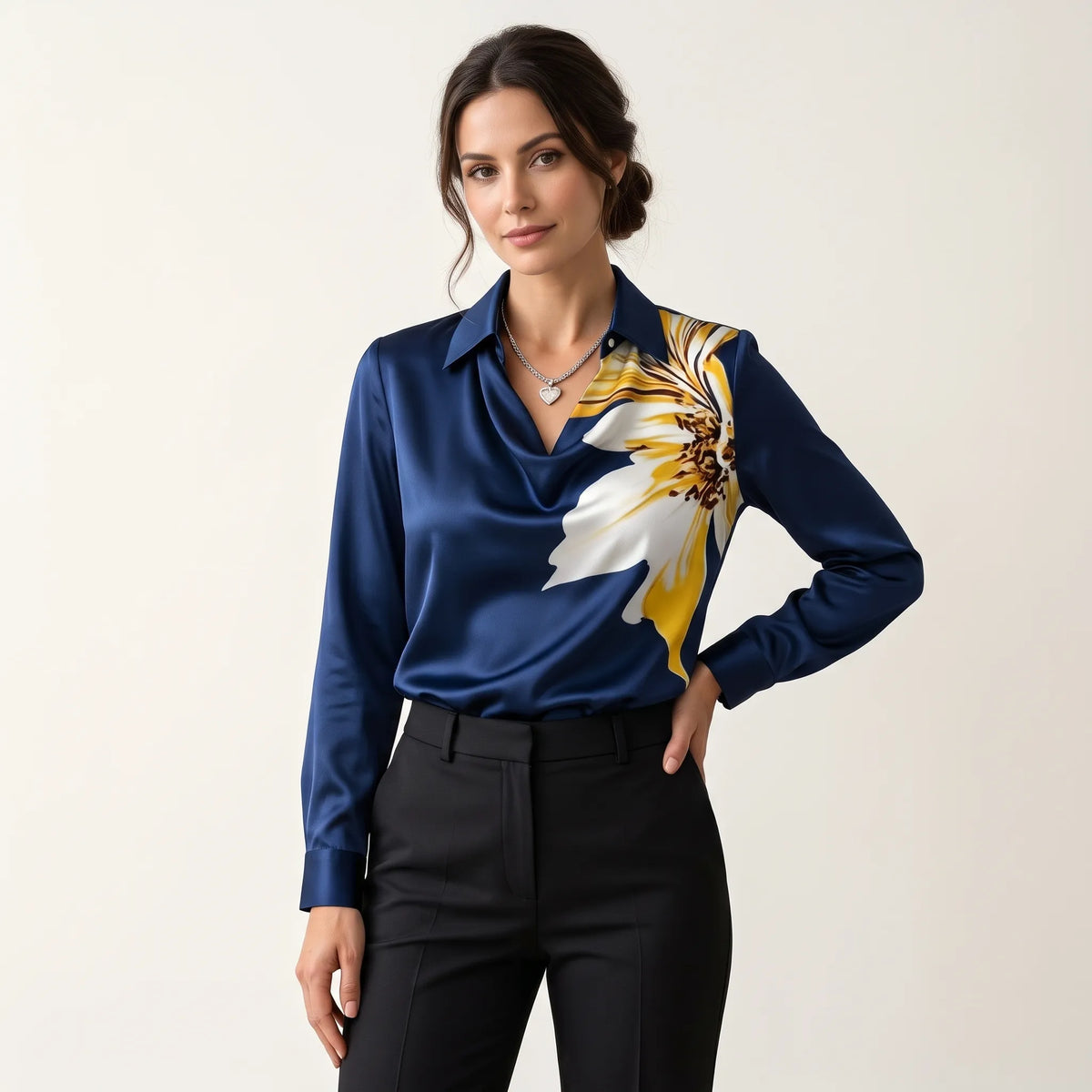Model in a navy satin blouse with large yellow and white flower print, black trousers 14