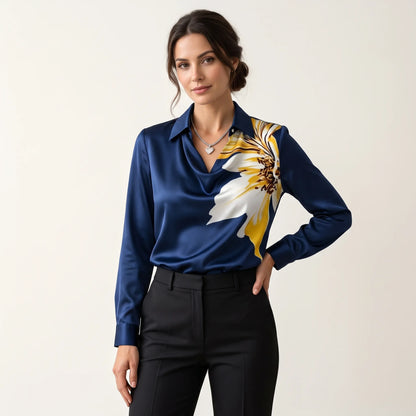 Model in a navy satin blouse with large yellow and white flower print, black trousers 14