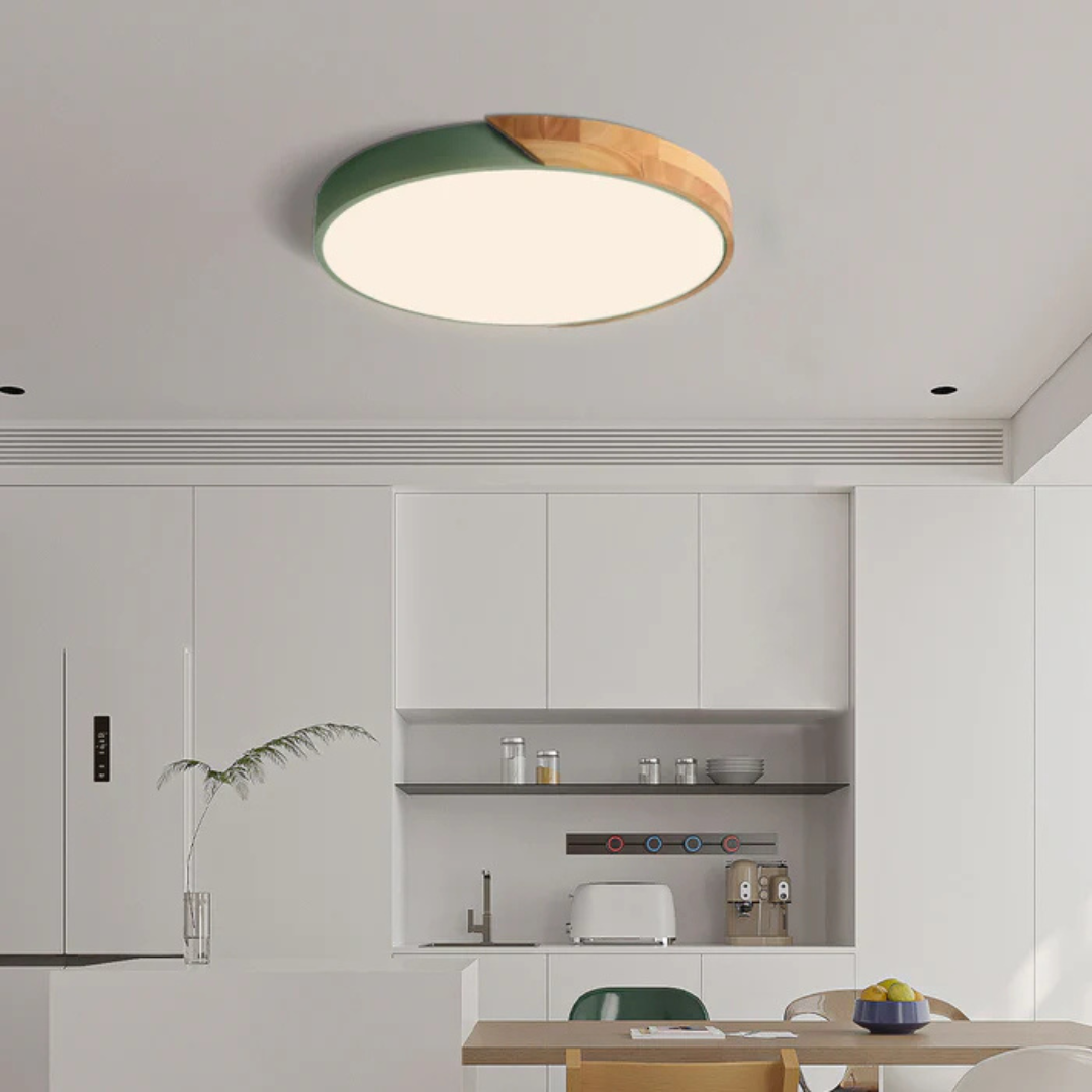 Green and wood round ceiling light above a white kitchen with open shelving and a dining table 3