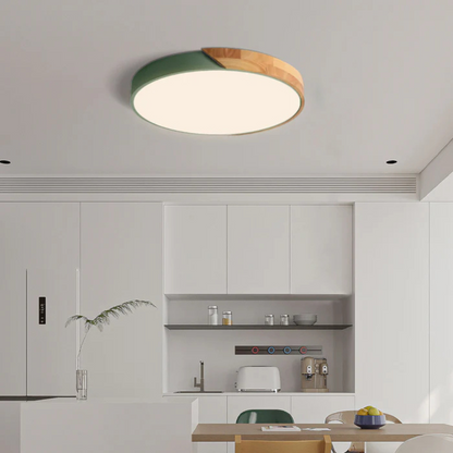 Green and wood round ceiling light above a white kitchen with open shelving and a dining table 3