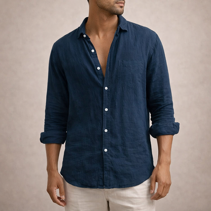 Navy linen shirt with a chest pocket, worn by a model with sleeves rolled and a casual open collar. 7