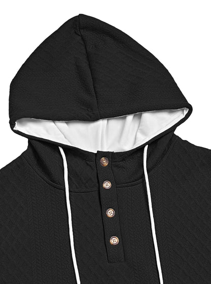 Close-up of a black hoodie's hood and four-button placket with white drawstrings against a plain background 15