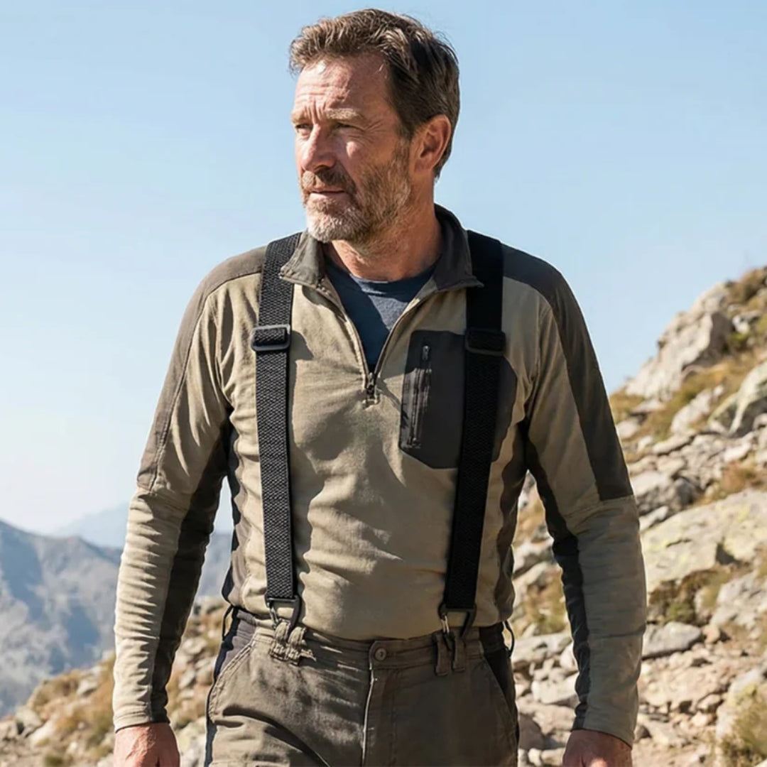 Bearded man on a mountain trail wearing black braces over a khaki fleece top 16