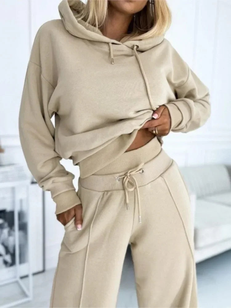 Tight crop of the beige hoodie and drawstring trousers, showing ribbed waistband and seam detail 15