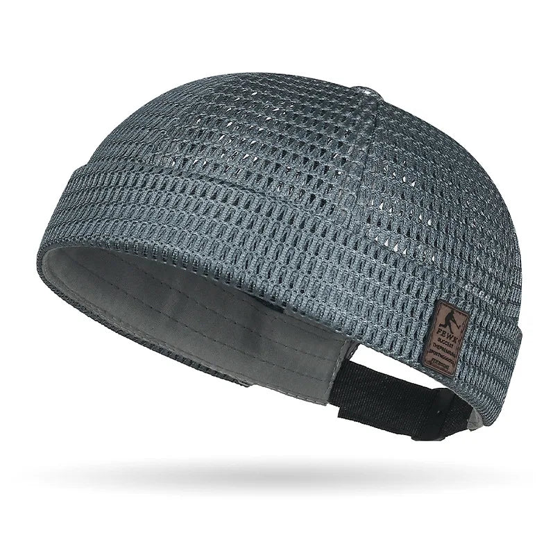 Slate grey open weave brimless cap with small leather-look patch and adjustable back strap 16