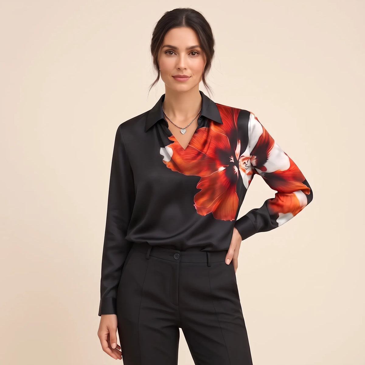 Model in a black blouse with bold orange and white floral print over shoulder and sleeve 16