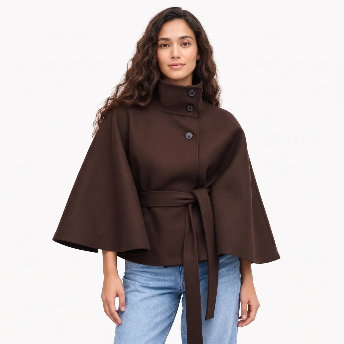 Studio shot of the dark brown cape jacket with jeans, three dark buttons and a belt 16