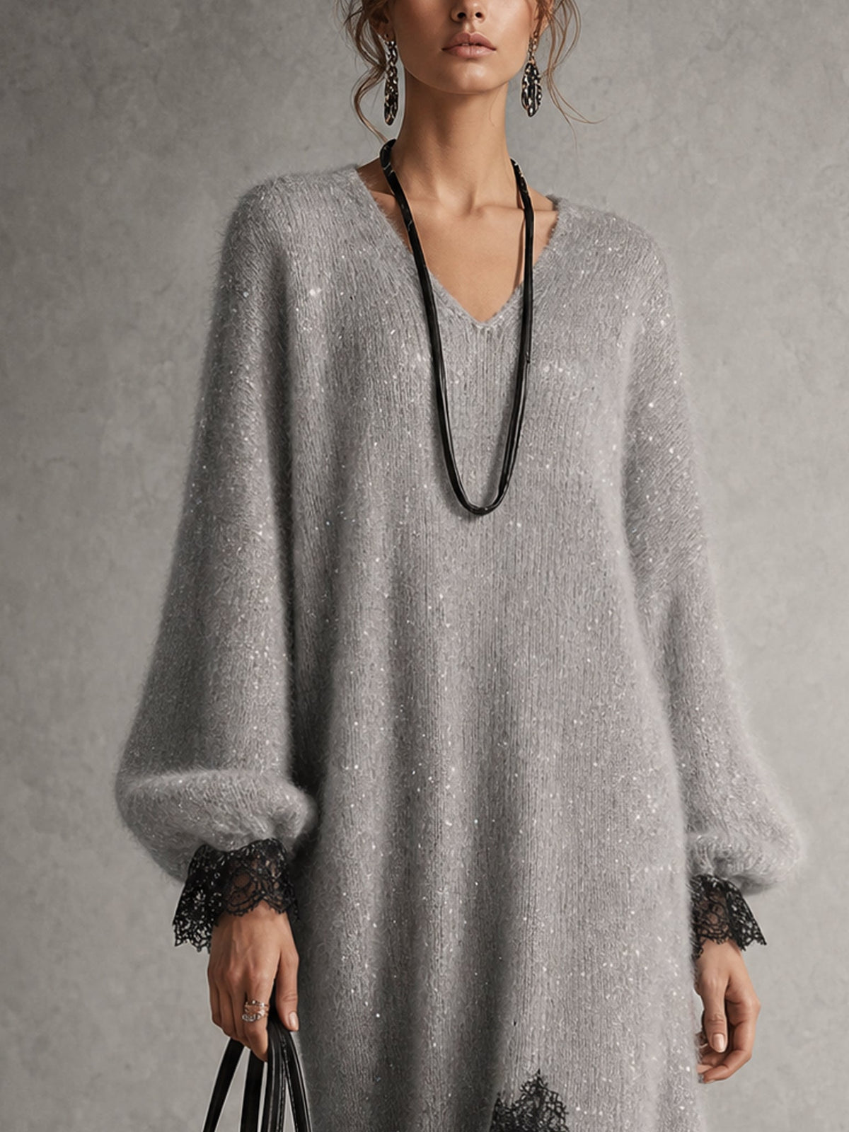 Close-up of the grey sparkly knit, V-neckline, puff sleeves and black lace cuffs 6