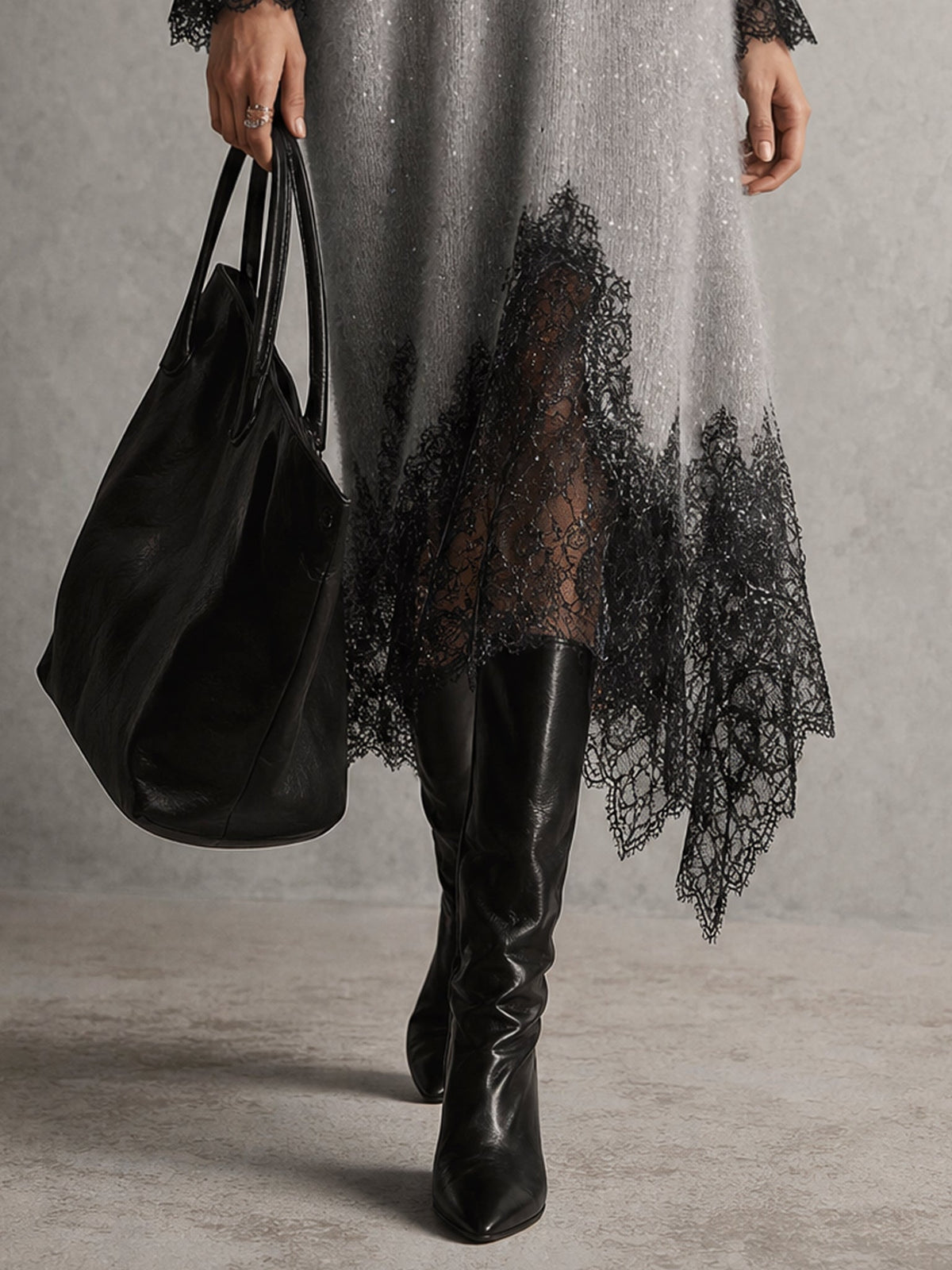 Close-up of the sheer black lace hem with pointed edges, worn with black leather boots 7
