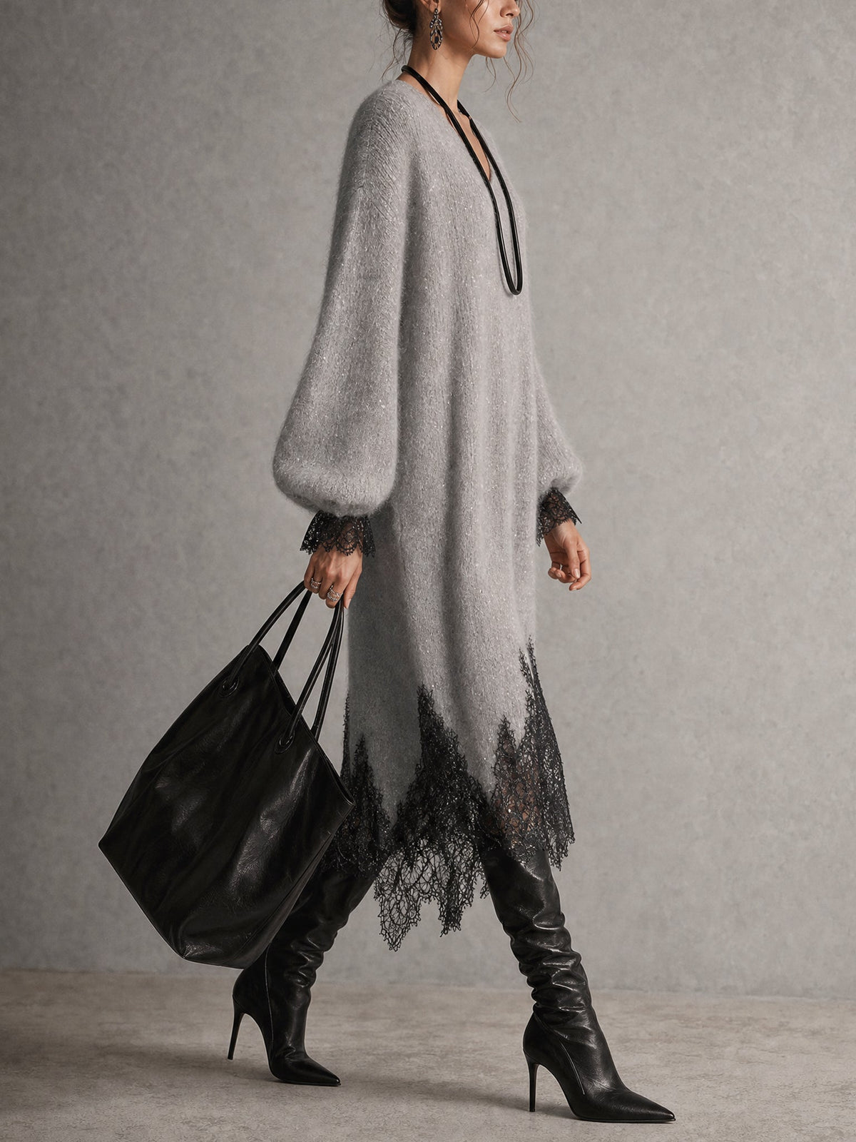 Side view of the grey dress showing the full puff sleeve and uneven lace hem 5