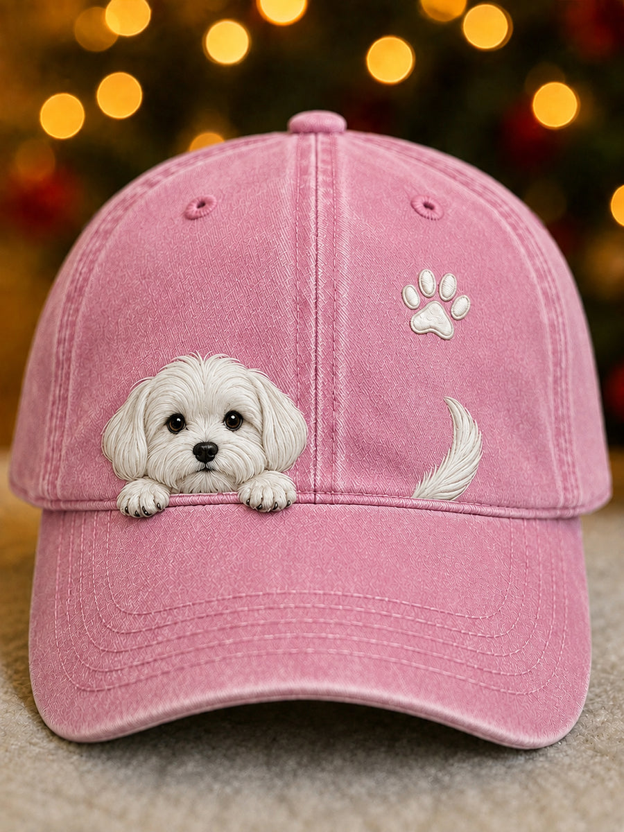 Front view of the cap in pink with a white peeking puppy over the peak, a paw print and a curled tail. 2