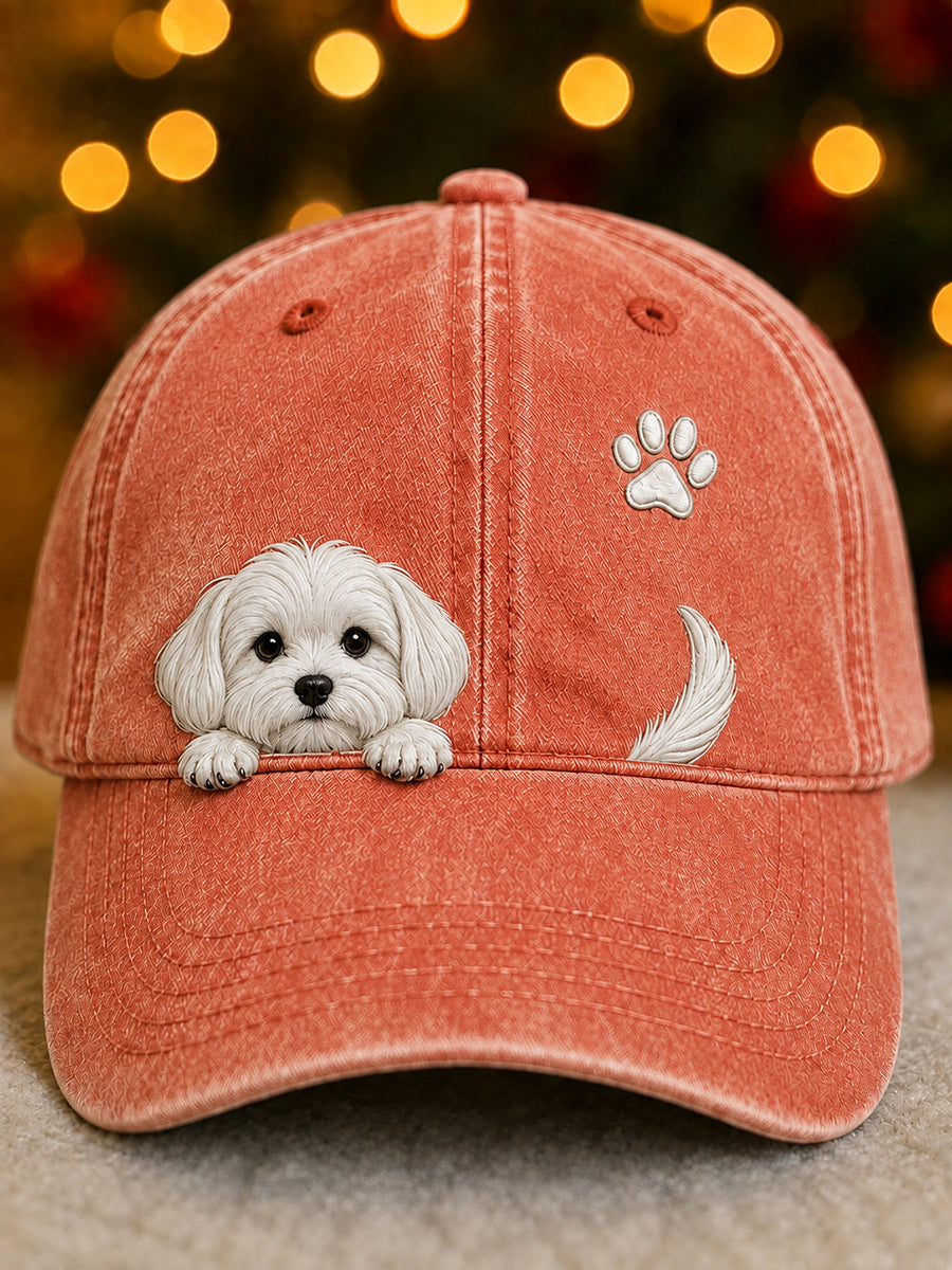 Front view of the cap in coral orange with a white puppy peeking over the peak, a paw print and tail. 5