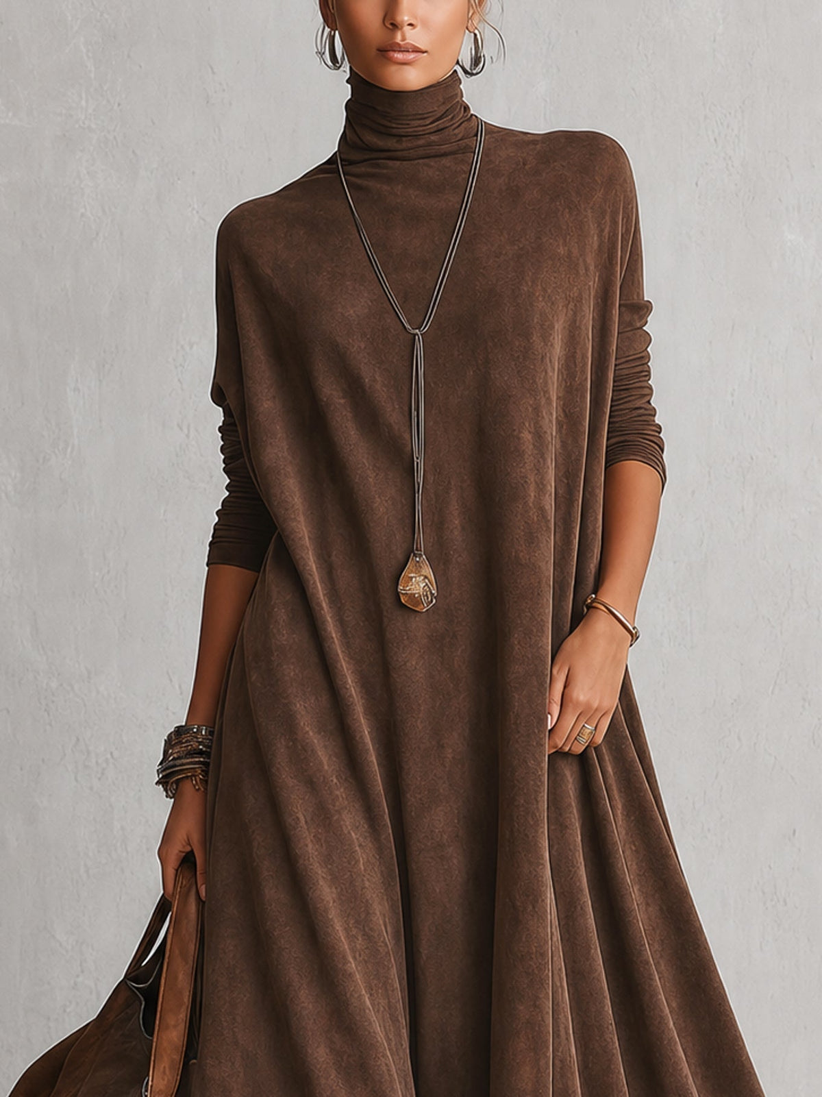 Close-up of the brown high-neck bodice and long sleeves, worn with a pendant necklace 7