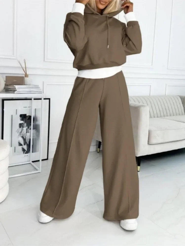 Full-length view of the brown set with contrast white cuffs and waistband, worn with white trainers 17