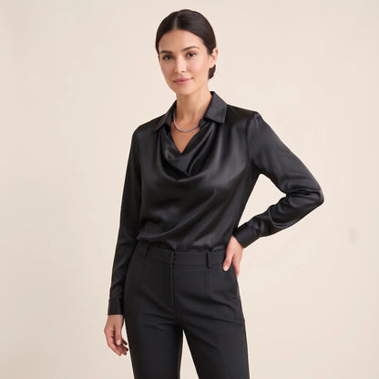 Model in a plain black satin blouse with draped neckline, black trousers and silver chain necklace 17