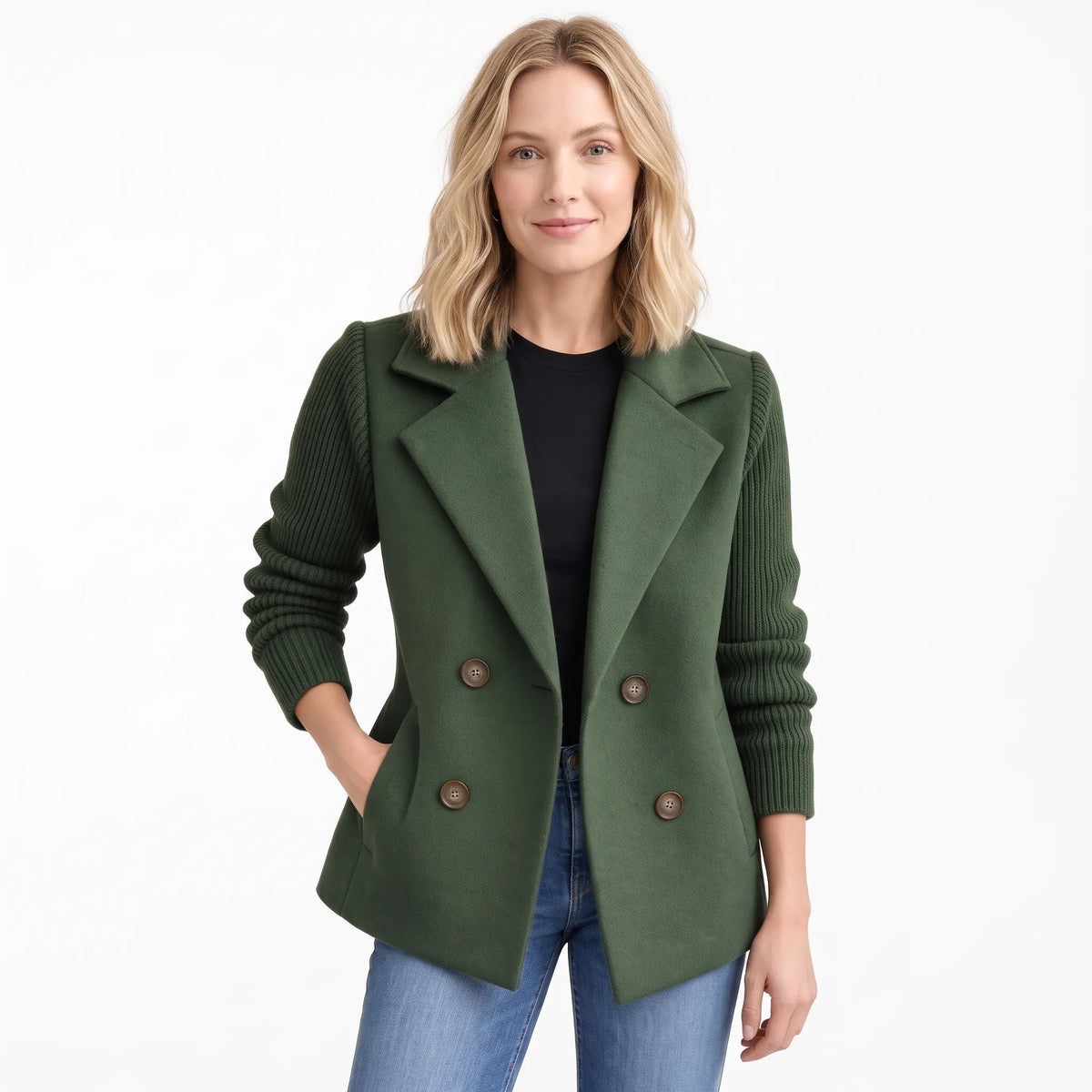 Studio shot of model in dark green double-breasted jacket with ribbed knit sleeves and jeans 17