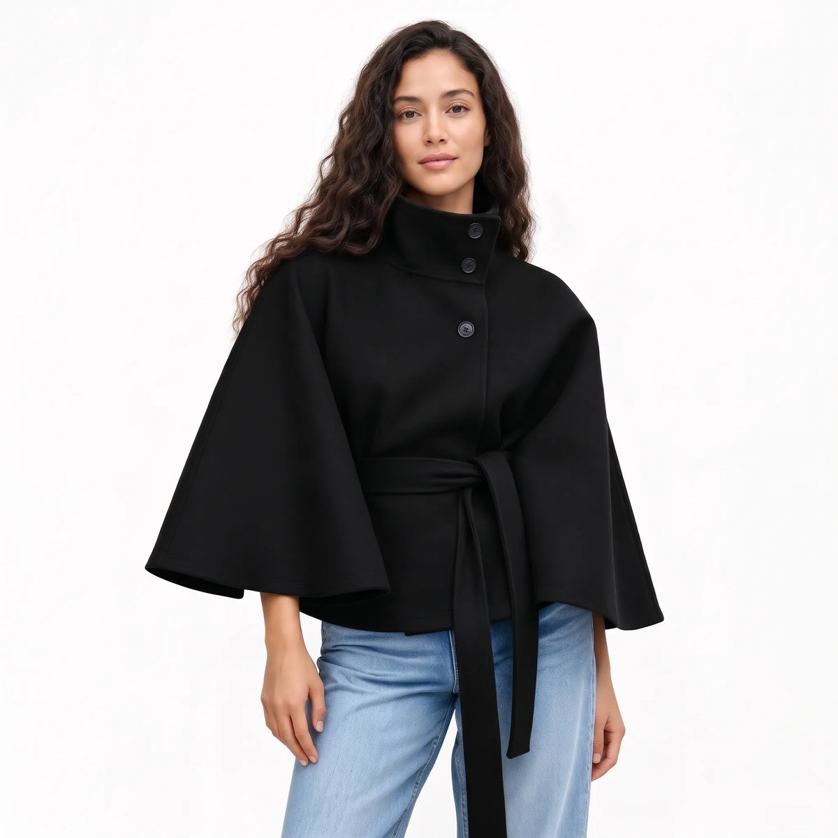 Studio shot of the black cape jacket worn with jeans, high collar buttoned, belt tied 17
