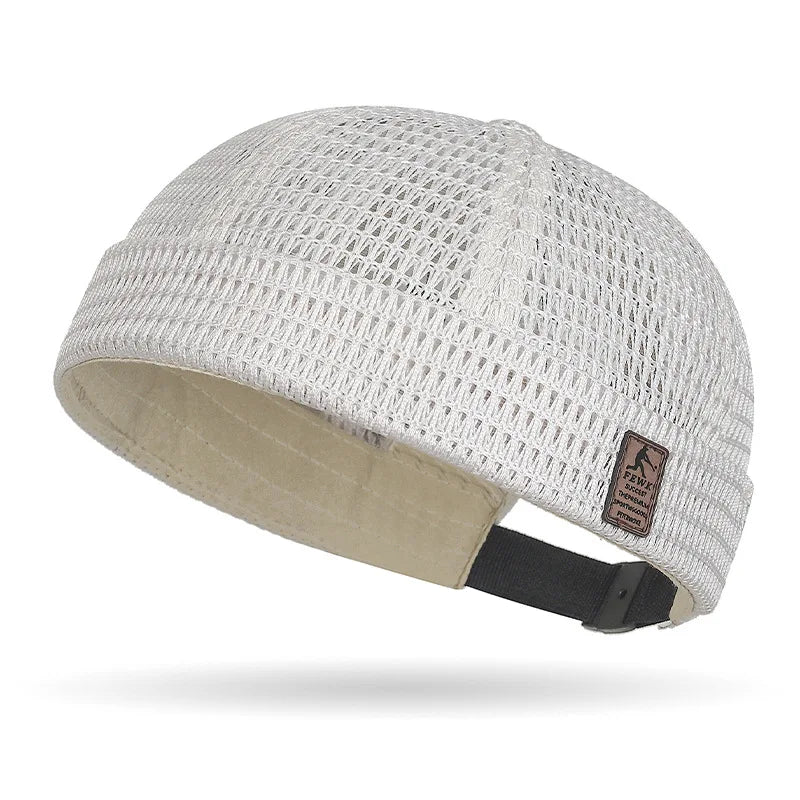 Cream open weave brimless cap with a patch on the cuff and black adjustable strap 17