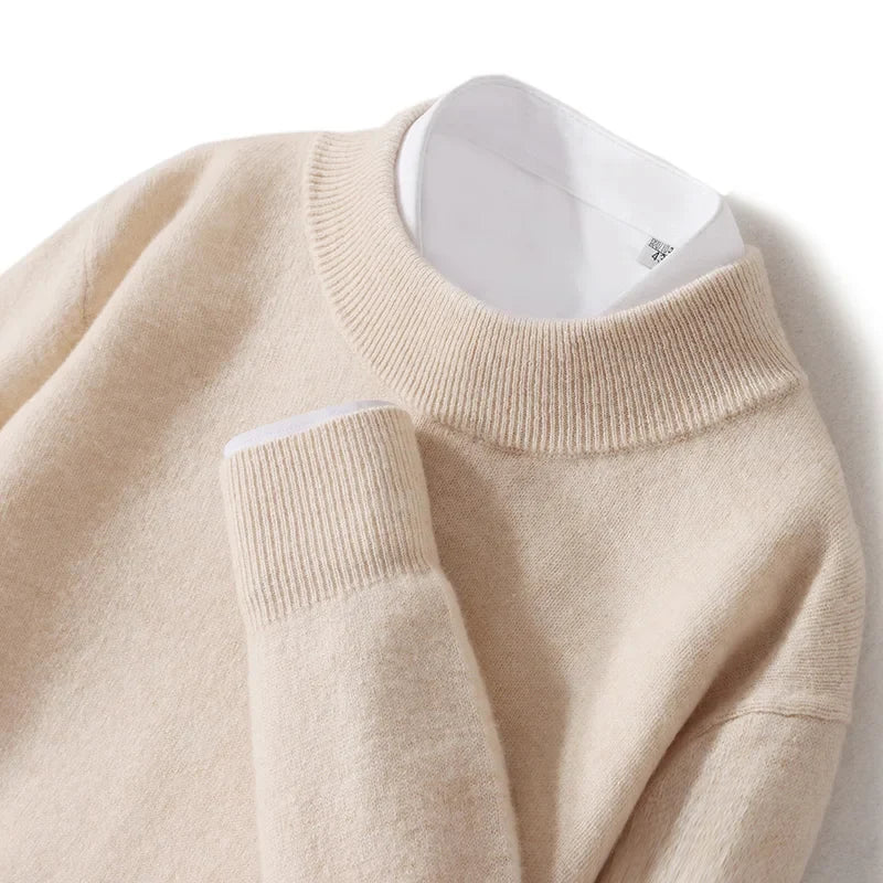 Close-up of the cream jumper's ribbed mock neck and cuff, layered over a white shirt 17