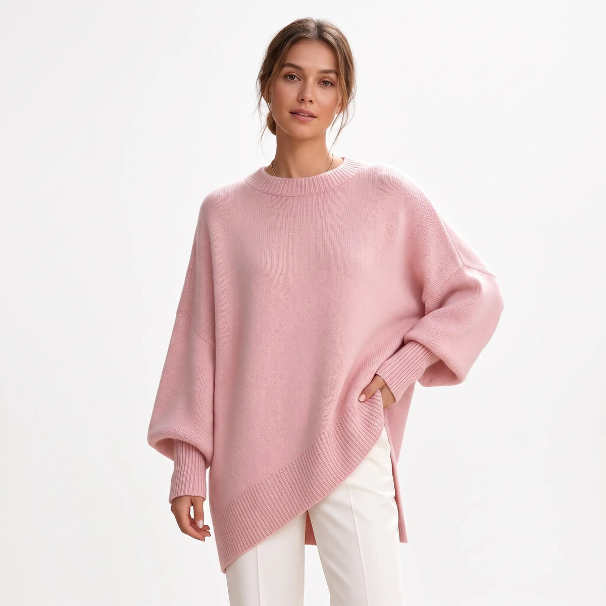 Studio shot of the pink jumper with ribbed neck and cuffs, paired with white trousers 17
