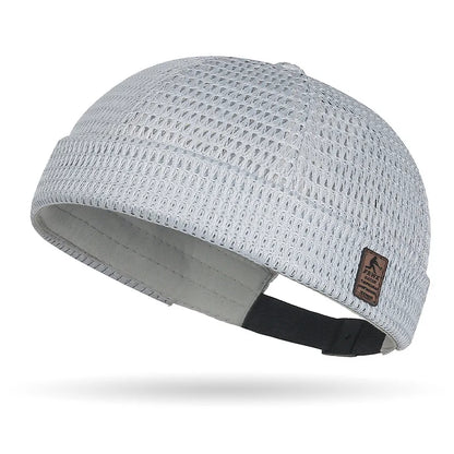 Light grey open weave brimless cap showing the mesh texture and adjustable strap 18