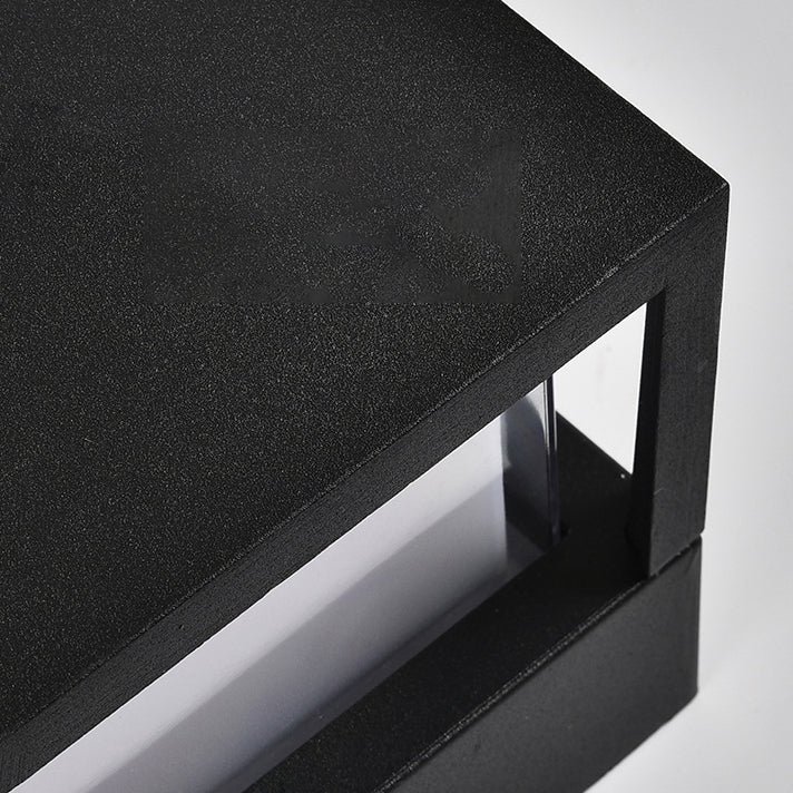 Close-up of the textured black metal top and corner frame of a square light, with clear panel below. 5