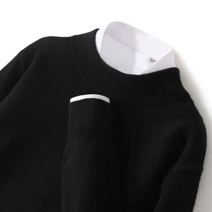 Close-up of the black jumper's ribbed mock neck and cuff, with white shirt underneath 18