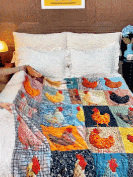 Colourful chicken patchwork blanket draped across a made bed with white pillows 6
